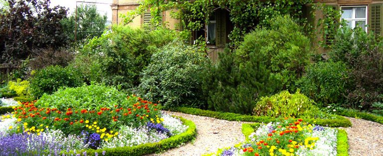 Colourful flower beds and shrubs in front of a home